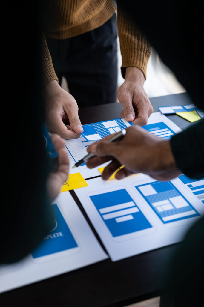 Brainstorm mobile app interface layout design ideas on graphic designer table.ux graphic designer creative sketch planning Mobile web prototype development process vertical image